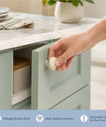 Upgrade Your Cabinets With This Sweet Set Of Sixteen Coral Pink Ceramic Cabinet Knobs Featuring Smooth Round Profiles No Sweat Installation And Top Shelf Hardware. Hand reaching for a vintage round ceramic knob on a mint green cabinet.
