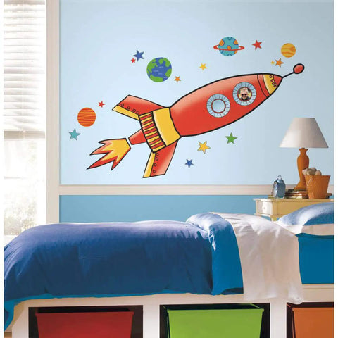 Rocket Giant Peel And Stick Wall Decals With Growth Chart Included For Kids Room Makeover Removable And Repositionable Easy To Apply On Any Smooth Surface Made In Usa on a blue wall above a bed.