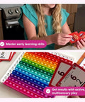 Child playing with Number Ninja Multiplication And Division Game For Grades 2 Through 4 with colorful learning cards.