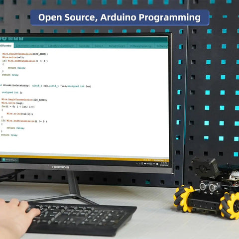 Arduino Compatible Smart Robot Car With AI Vision Camera And Line Tracking For Target Recognition And Obstacle Avoidance STEM Educational Kit next to a computer monitor displaying code.