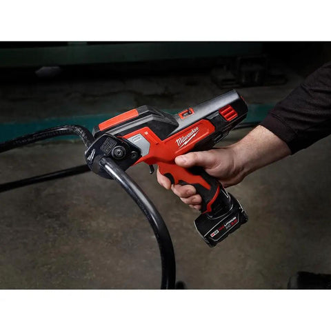 Heavy Duty Cordless Ratcheting Cable Cutter Kit Packs Serious Punch To Easily Rip Through 600 MCM Copper And 750 MCM Aluminum With Low Profile Jaws Built For Cramped Electrical Panels, held in hand.