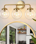 Three Light Vanity Wall Sconce Over Mirror In Matte Gold Finish With Transparent Glass Ball Shade