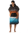 Kids Hooded Changing Poncho Towel For Beach And Pool Microfiber Quick Dry Swim Poncho Soft Suede Like Fabric Lightweight And Absorbent Easy To Change In Front Pocket Kid Sized Ideal For Boys And Girls Sunset Drift Small shown being worn.
