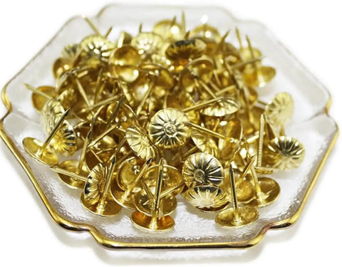 Top Tier 500 Piece Gold Metal Upholstery Tacks For Furniture Reupholstering And Cork Boards in decorative dish close-up.