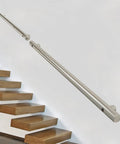 Get Grip Of Safety With This Badass Stainless Steel Hand Rail Grab Bar Designed For Outdoor Steps Decks And Porches Wall Mounted And Rock Solid Construction Allows Custom Lengths Up To 18 Feet Make Sure Your Walkway Is Secure With Heavy Duty Metal, showing a stainless steel handrail mounted above wooden steps.
