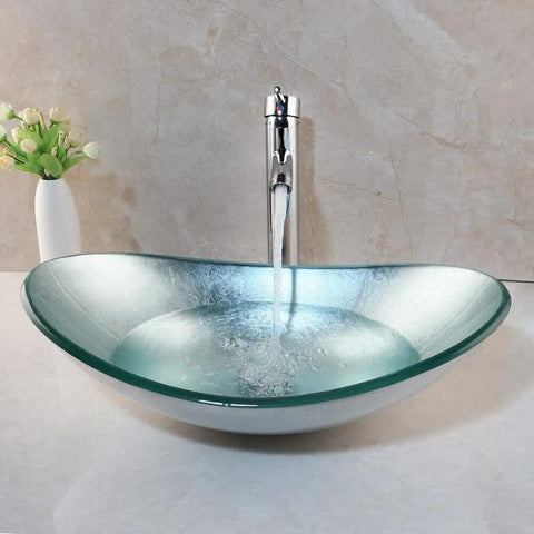 Artistic Tempered Glass Oval Vessel Sink Above Counter with Chrome Faucet and Pop Up Drain in Silver Finish
