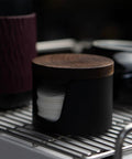 Slick Swivel Coffee Filter Paper Holder And Brewing Tool Caddy with dark wood lid, holding filter papers, sleek design.