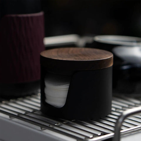 Slick Swivel Coffee Filter Paper Holder And Brewing Tool Caddy with dark wood lid, holding filter papers, sleek design.
