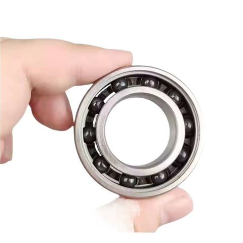 Stainless Steel Hybrid Ceramic Bearing 30x42x7 mm ABEC-7 for bicycle bottom bracket, hand holding, close-up view.