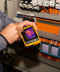 Person using PTi120 Pocket Thermal Imager For Quick Infrared Inspections And Temperature Scans On The Go near electrical panel