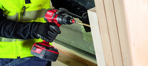 Cordless Hammer Drill Driver SF 6H A22 Bulk For Brick Masonry And Concrete Jobs in use on wooden surface by worker
