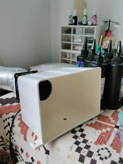 Heavy Duty Desktop Smoke Absorber For Soldering With Flexible Hose on a table, showcasing its boxy white design and exhaust port.