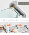 Detail of heavy duty glass bathroom shelf with towel bar and rail, brushed nickel finish with four high-strength suction cups for stability.
