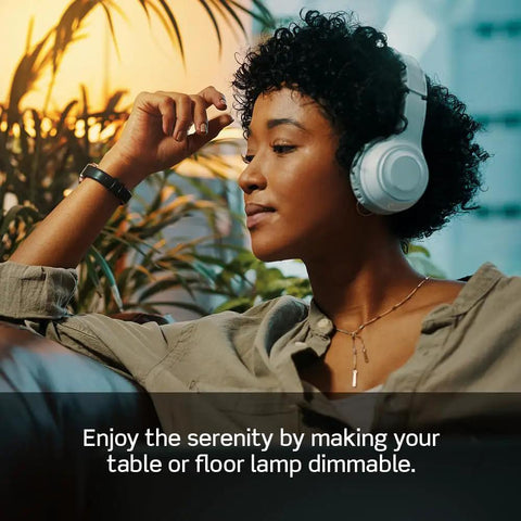 Person enjoying music while using the Table Top Plug In Lamp Dimmer Switch Compatible With Dimmable Led Halogen And Incandescent Bulbs Up To 300 Watts Black Outlet Adapter.