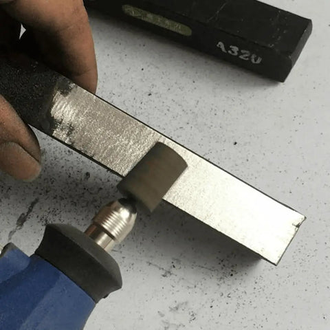Grinding tool using Six Piece 16 mm Cylinder Grinding Stones With One Quarter Inch Shank Aluminum Oxide Mounted Grinding Bits For Drill And Rotary Tools, Durable Sharpening Bits For DIYers And Pros For Metalworking Jewelry Woodworking And Hobby Projects on metal surface