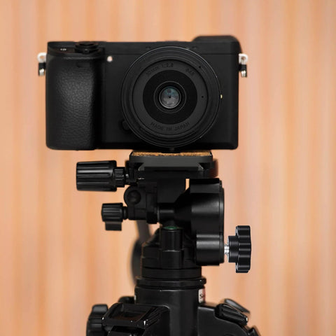 Camera on tripod featuring 12 Pack 1/4-20 Black Star Knobs With Grippy Knurled Hand Grip, durable design for adjustments.