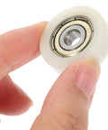 Rock Solid Replacement Sliding Door Wheels With Heavy Duty Nylon And Steel Build Ultra Quiet Zero Friction Caster Rollers close-up held in hand.