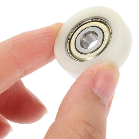 Rock Solid Replacement Sliding Door Wheels With Heavy Duty Nylon And Steel Build Ultra Quiet Zero Friction Caster Rollers close-up held in hand.