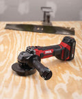 Cordless 20V Go To Four And A Half Inch Angle Grinder with PWRCore 20 Battery and Charger on wooden surface