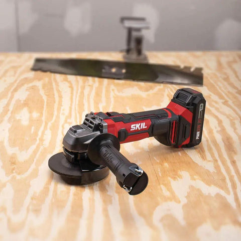 Cordless 20V Go To Four And A Half Inch Angle Grinder with PWRCore 20 Battery and Charger on wooden surface