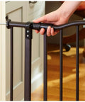 Person installing Portico Arch Baby Gate for Doorways and Hallways, Heavy Duty Metal Safety Gate with One Hand Operation, Pressure Mount