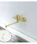 ntumLeap Brushed Nickel Wall Mounted Kitchen Faucet 180° Rotating Hot & Cold Water Mixer, gold finish, washing dishes in sink.