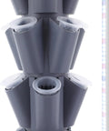 Close-up of grey Vertical Hydroponic Garden Tower With 70 Pods And 14 Tiers, showing planting holes and LED light strip.