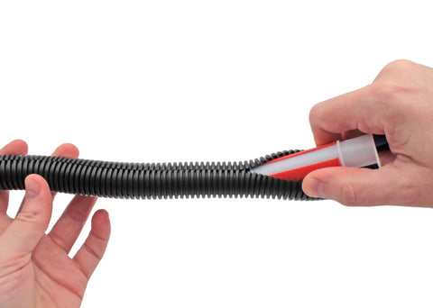 Close-up of Wire Loom Insertion Tool Set For Three Eighths To Two Inch Conduit Sleeving in use with black conduit sleeve.