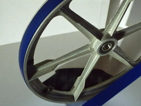Close-up of Blue Ultra Duty Band Saw Tires For 33 WM14 Band Saw Beefed Up Urethane Replacement Part showing tire and metal frame.