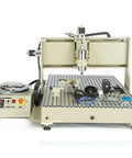 4 Axis CNC Router Engraver 6090 For Wood Metal PVC Desktop DIY Milling Cutter With 1.5KW Water Cooled VFD Spindle 3D Carving Machine USB Engraving Port Heavy Duty Machining For Metal Wood And PVC in neutral surroundings, showing full machine layout including spindle and control box.