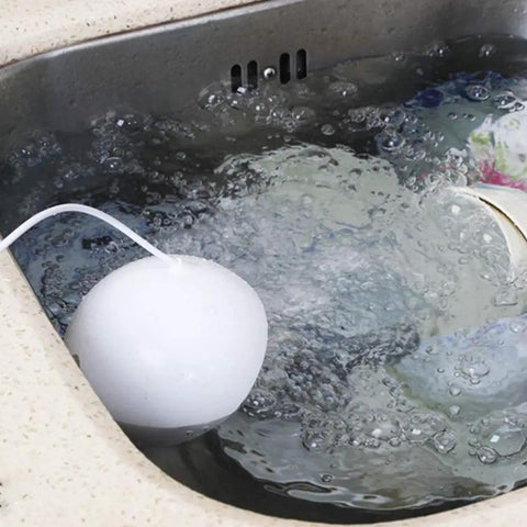 Slick Portable Usb Dishwasher With Ultrasonic Deep Clean And High Pressure Water Spray That Tackles Greasy Pots And Pans Hassle Free For Small Kitchens Apartments Or Rv Outings In Matte Blue submerged in bubbling water.