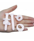 Tough As Nails Universal Plastic Toilet Seat Hinge Screw Bolt Kit components held in a hand, featuring rust-resistant plastic materials.