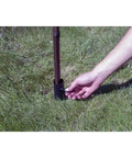Hand installing Ns Torch Stake For Outdoor Lighting, Heavy Duty Garden Torch Stake With Easy Inground Install into grass for patio paths.