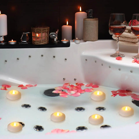 48 Pack Floating LED Candles Water Activated Battery Powered Flameless Flicker Lights For Baby Shower Wedding Home Party Decor Warm White Glow Real Paraffin Wax Safe And Waterproof in bathtub setting with rose petals.