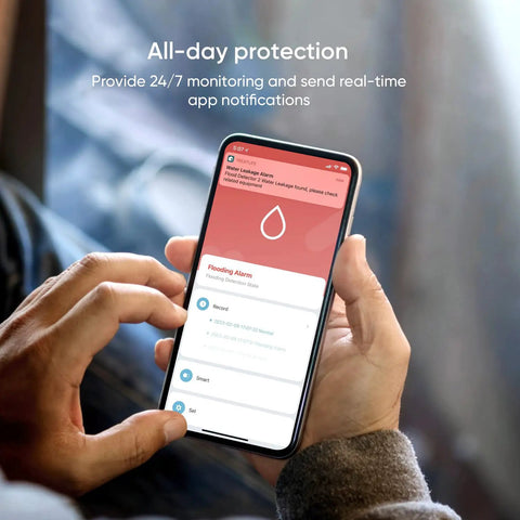 Person holding smartphone showing Smart Water Leak Detector 4 Pack With Zigbee Hub Kits Leak Alarm app interface in hand