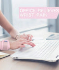 Person wearing pink 2 Pack Adjustable Wrist Brace For Sports Pain Relief And Injury Recovery using laptop in office