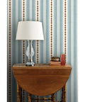 Custom Printed Vinyl Wall Covering With A Subtle Leather Look And Modern Stripe Pattern on wall with lamp and wooden table.