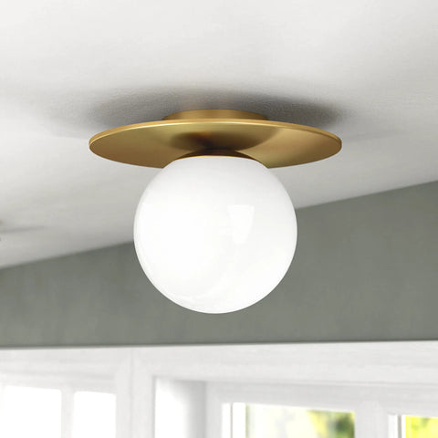 Low-Profile 12 Inch 1-Light Flush Mount Ceiling Light Fixture With White Milk Glass Globe Shade In Brushed Gold installed on ceiling