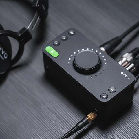 EVO4SRB Start Recording Bundle 2x2 USB audio interface with cables and headphones on dark surface, home studio setup