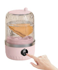 Slick Portable Laundry Wash Cup For Travel And Business Trips Compact Clothes Cleaner with water and clothes in pink design.