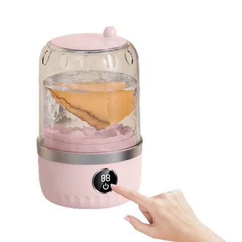 Slick Portable Laundry Wash Cup For Travel And Business Trips Compact Clothes Cleaner with water and clothes in pink design.
