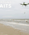 Waterproof Fishing Drone With 7 Pound Bait Release And 4K Camera flying over beach with bait in mid-air drop