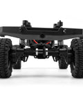 Close-up of 12 24T Steel Helical Axle Gear Set for 1 24 RC Cars FCX24 FCX18 installed on rear axle with wheels and suspension.