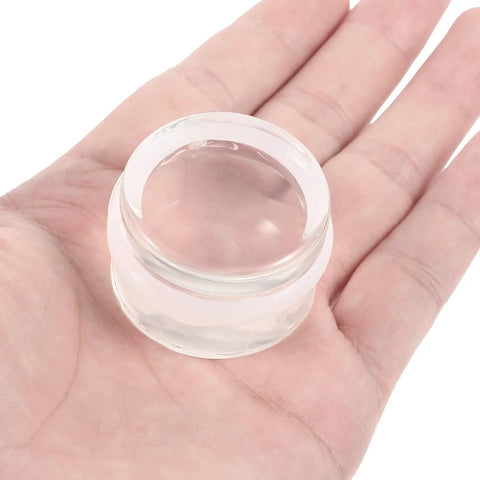 Clear silicone furniture accessory in hand, part of Two Pack Silicone Door Stopper Wedges To Prevent Finger Injuries And Door Slams Sturdy Furniture Accessories
