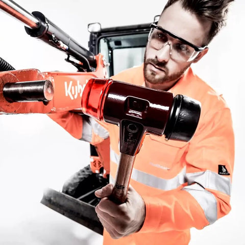 Worker using Beefy Soft-Faced Mallet With Dual Inserts Rubber Medium Hard Odorless Low-Wear And Oil-Resistant Plastic Hard Cast Iron Housing