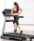 Women running on treadmill, using Universal Round Key Replacement, keeping fit with the Red Magnetic Treadmill Safety Key in home gym
