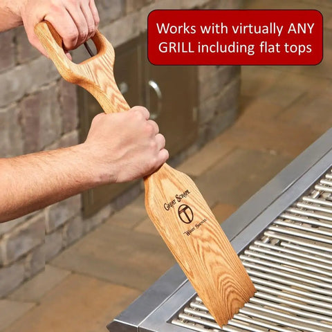 Man using Ultimate Bbq Cleaning Tool Shovel With Hardwood Grill Scraper And Long Reach Comfort Grip Handle on grill grate