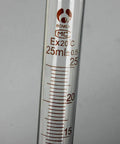 Close-up of 25ml measuring cylinder from Five Piece Glass Graduated Measuring Cylinder Set for Lab Chemistry, clear glass with gradations.