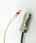 Close-up of a metal circular connector with knurled lock and black cable; yellow and white wires with red caps labeled B1/B2.