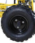 Close-up of a black tire on a 125cc Kids Go Kart With Reverse LED Lights Fully Automatic Transmission Two Seater Black For Kid Friendly Backyard Fun Easy To Control And Built For Big Backyard Adventures For All Ages.